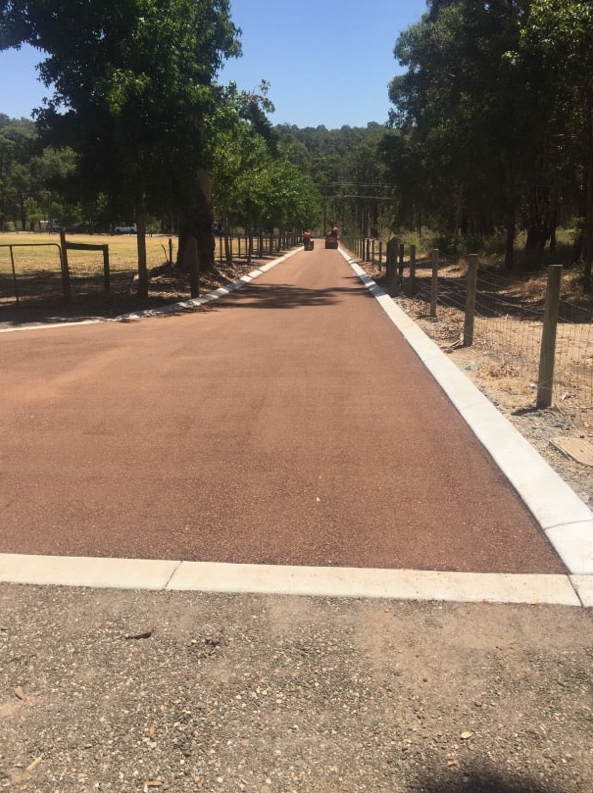 This is a photo of a hot spray & seal bitumen roadway which is in the process of being installed by Coburg Road Tech